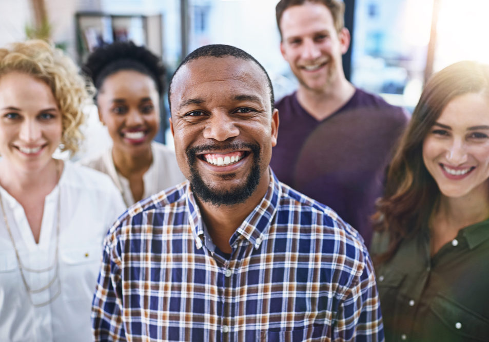 Happy black man, portrait and office with creative team in business startup, growth or diversity. African male person or employee in leadership for multicultural group, unity or about us at workplace.